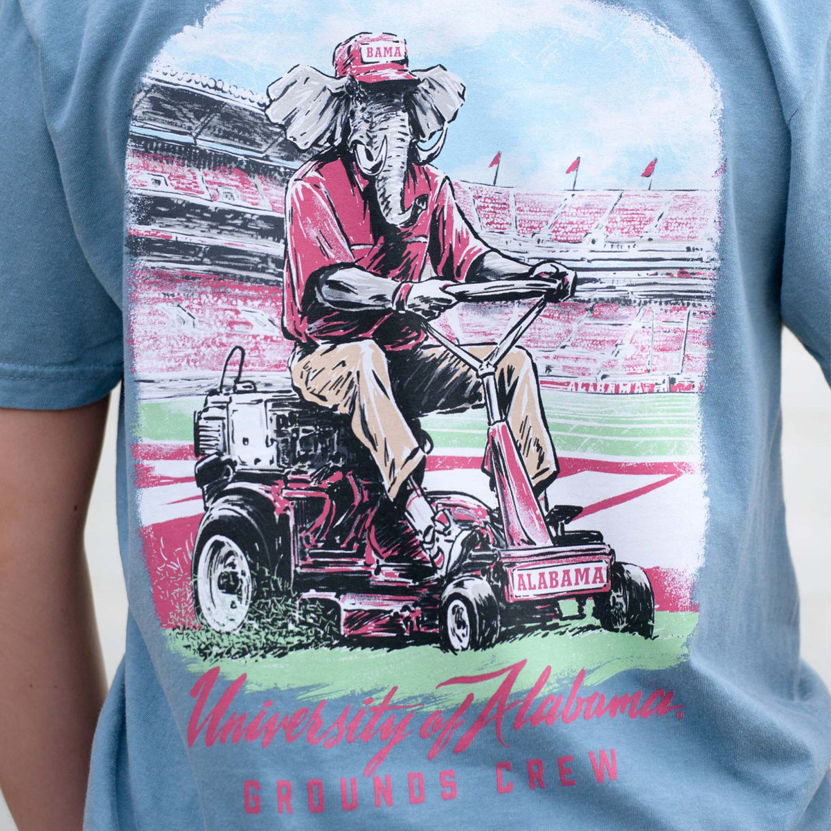 Detailed graphic on back of Big Al Grounds Crew tee with Big Al riding a mower and “University of Alabama Grounds Crew” text.