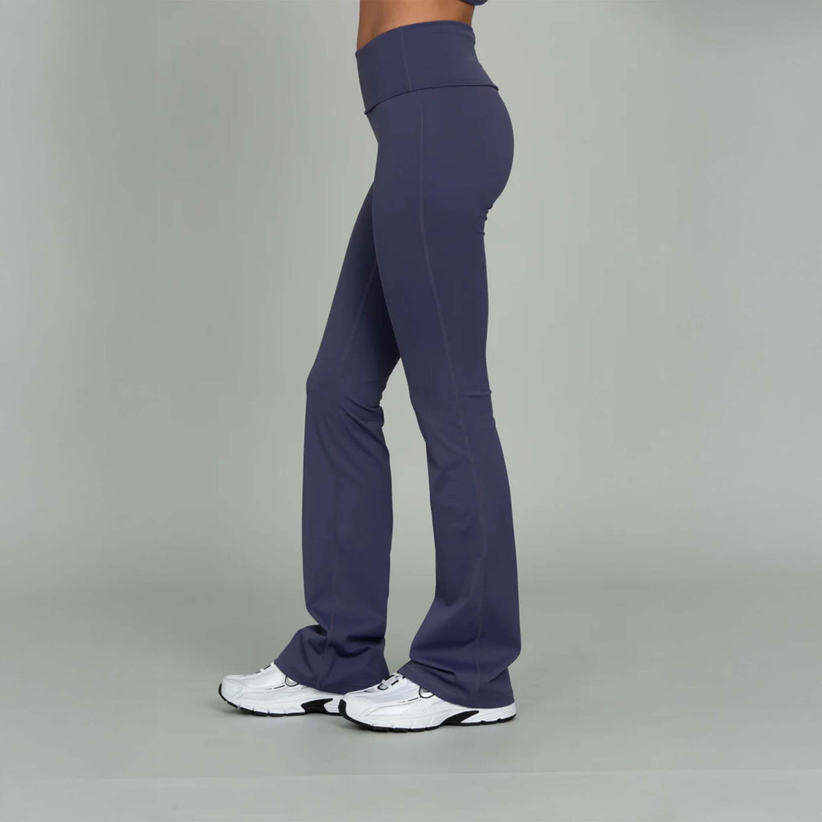 side view of Gold Hinge indigo fold over flare leggings paired with sneakers