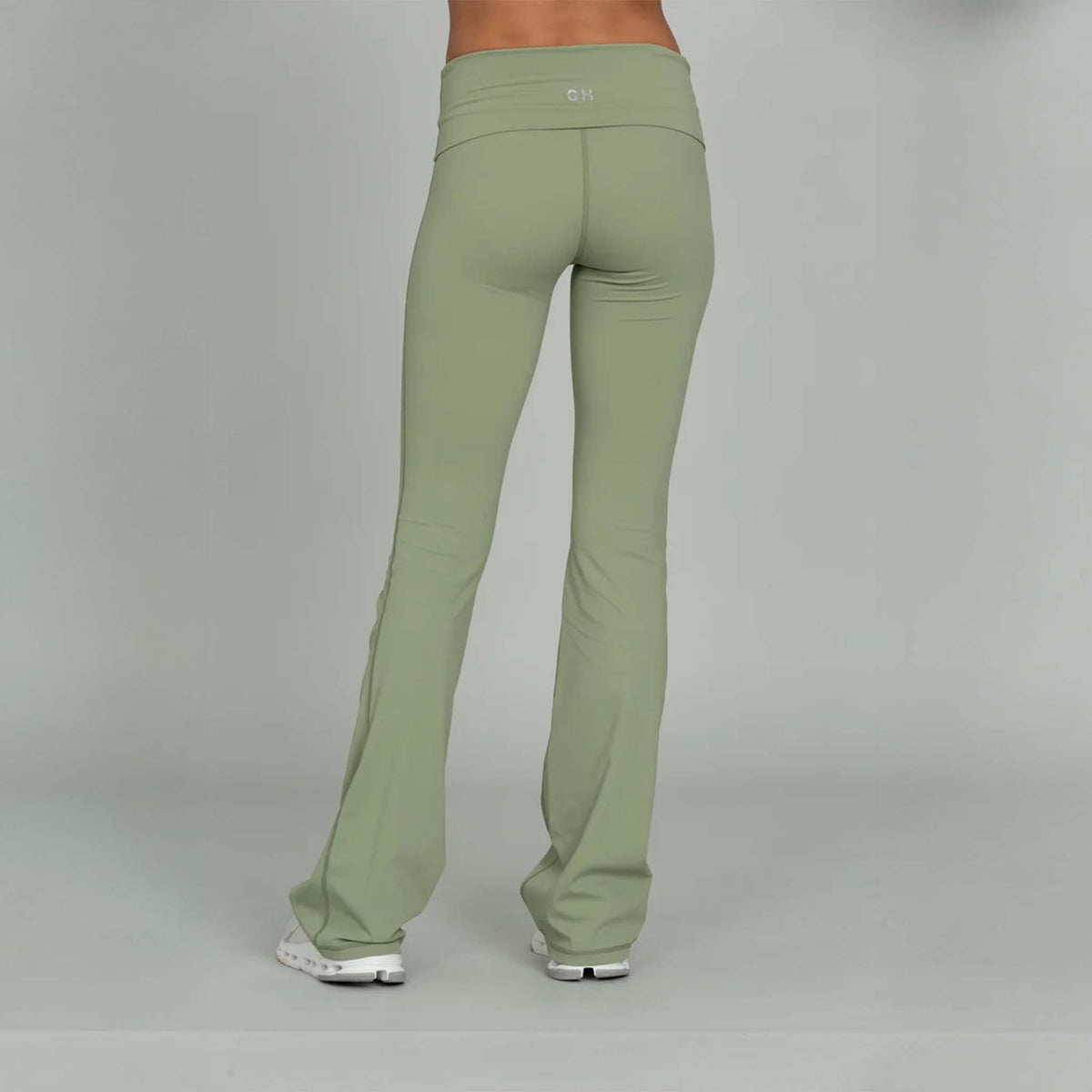 back view of Gold Hinge light green fold over flare leggings paired with sneakers