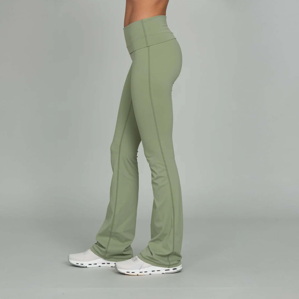 side view of Gold Hinge light green fold over flare leggings paired with sneakers