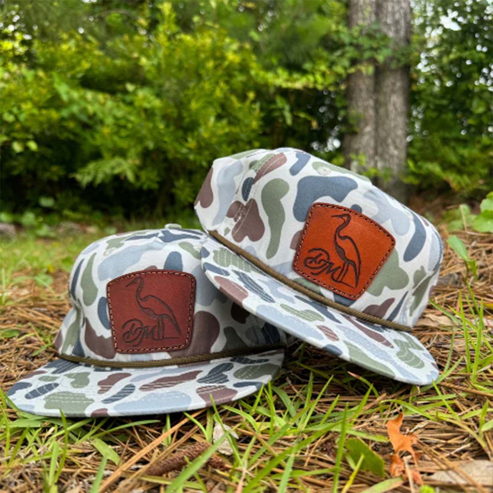 brackish camo hat featuring a logo leather patch on the crown and olive rope across the bill.