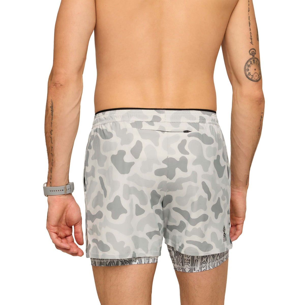 Back view of pastel grey camo athletic shorts with zippered back pocket and patterned compression liner hem.