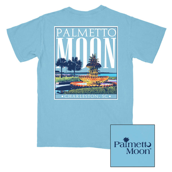  Palmetto Moon short sleeve t-shirt, unisex sizing.  On the back, this shirt has a vibrant design of Charleston's iconic Pineapple Fountain with palm trees and the Charleston Harbor in the background.  Typed in bold letters is Palmetto Moon, above, and Charleston, SC, below the design.   On the front, the Palmetto Moon logo is printed on the left chest.  Colors available are Sky Blue and Coral.  Made with 100% cotton, this shirt is perfect for all day wear! 