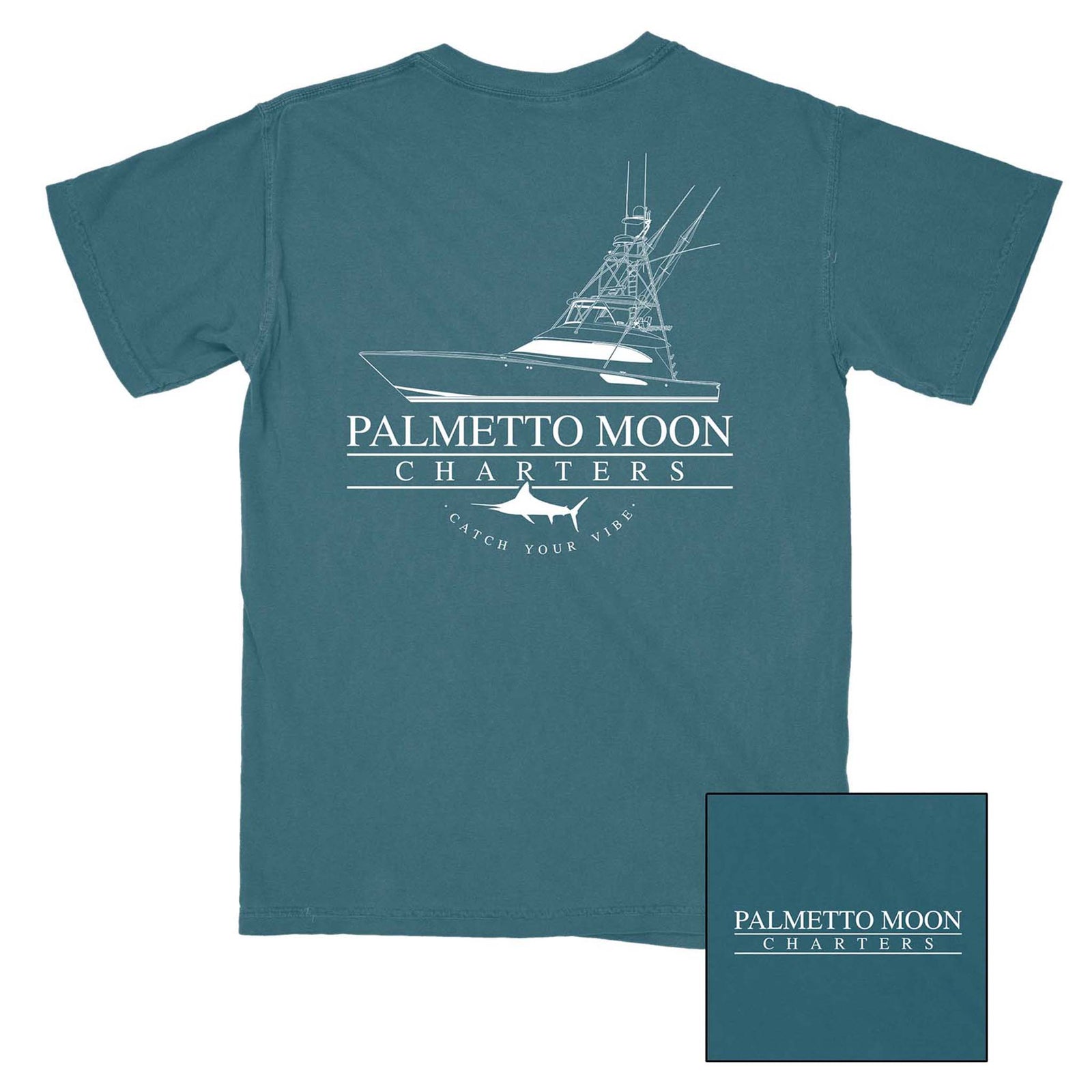 Palmetto Moon Marina tee in midnight blue with white graphic of a charter boat and shark. Features “Palmetto Moon Charters” and slogan “Catch Your Vibe” underneath.