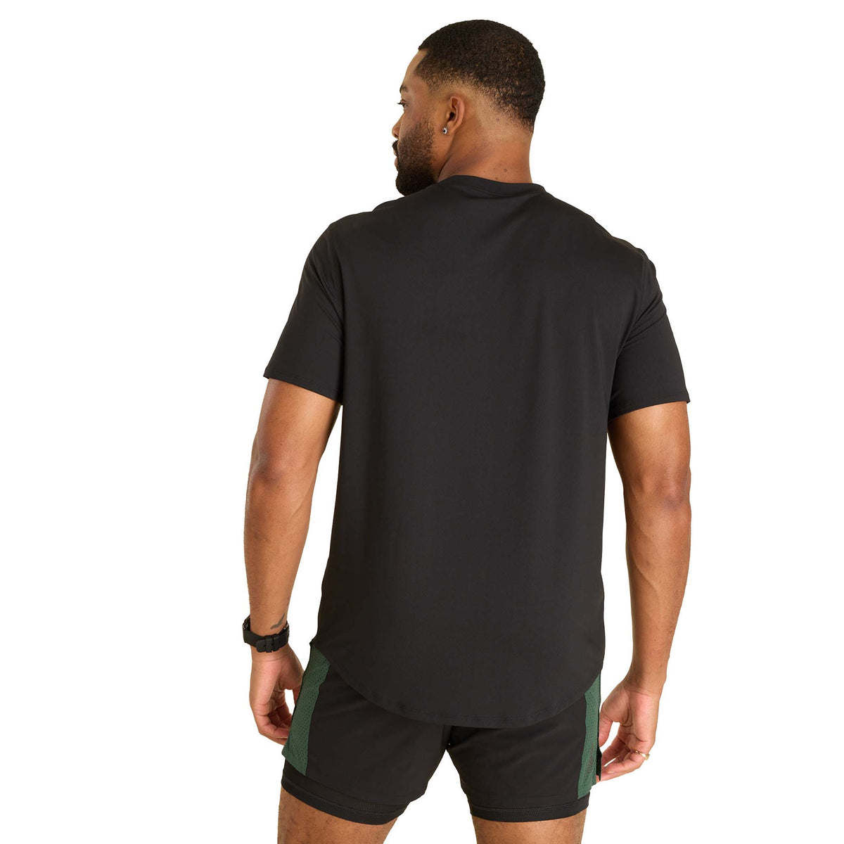 Man wearing a black t-shirt and shorts on a white background