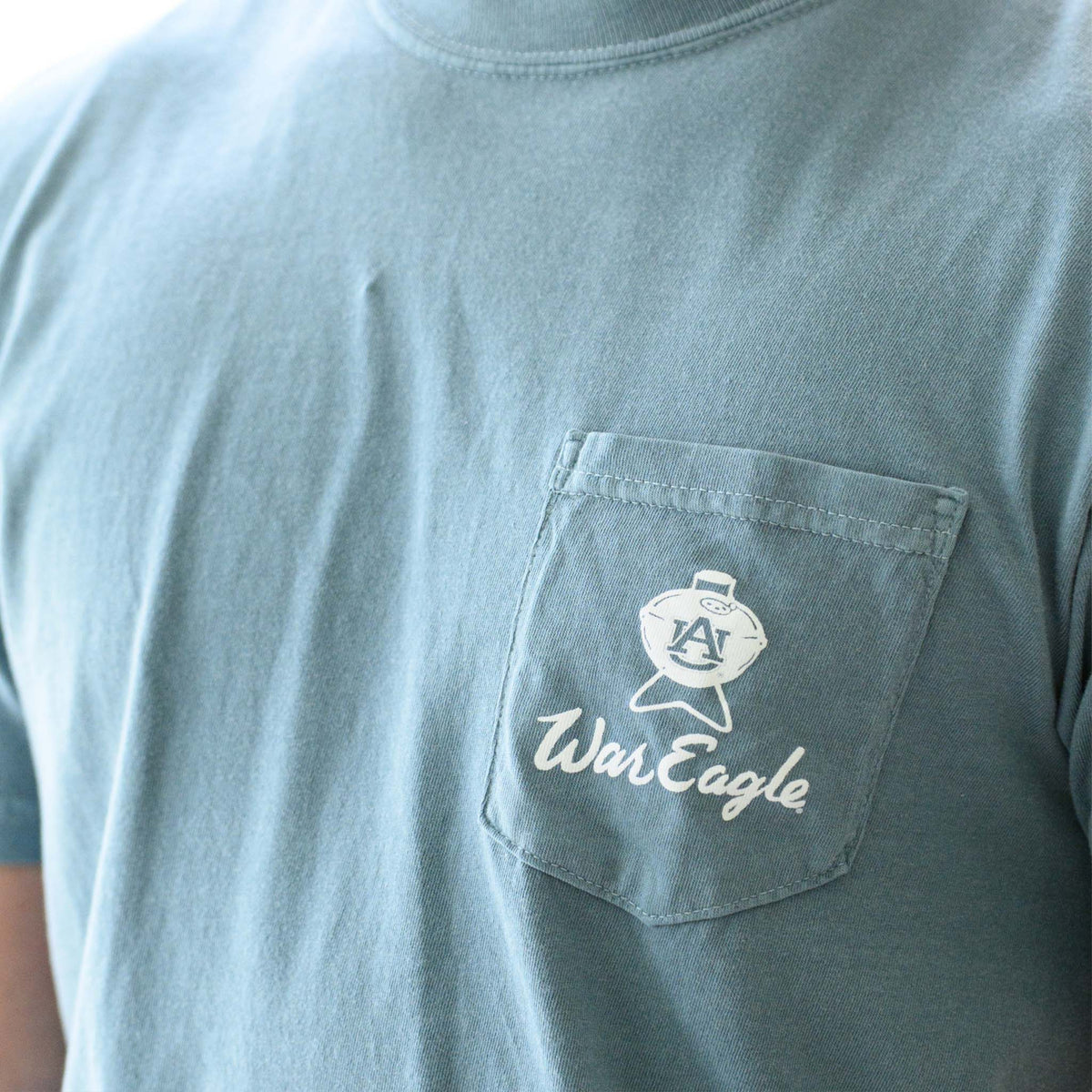 Front view of Auburn War Eagle Tailgate T-Shirt with pocket logo featuring AU grill and “War Eagle” script.