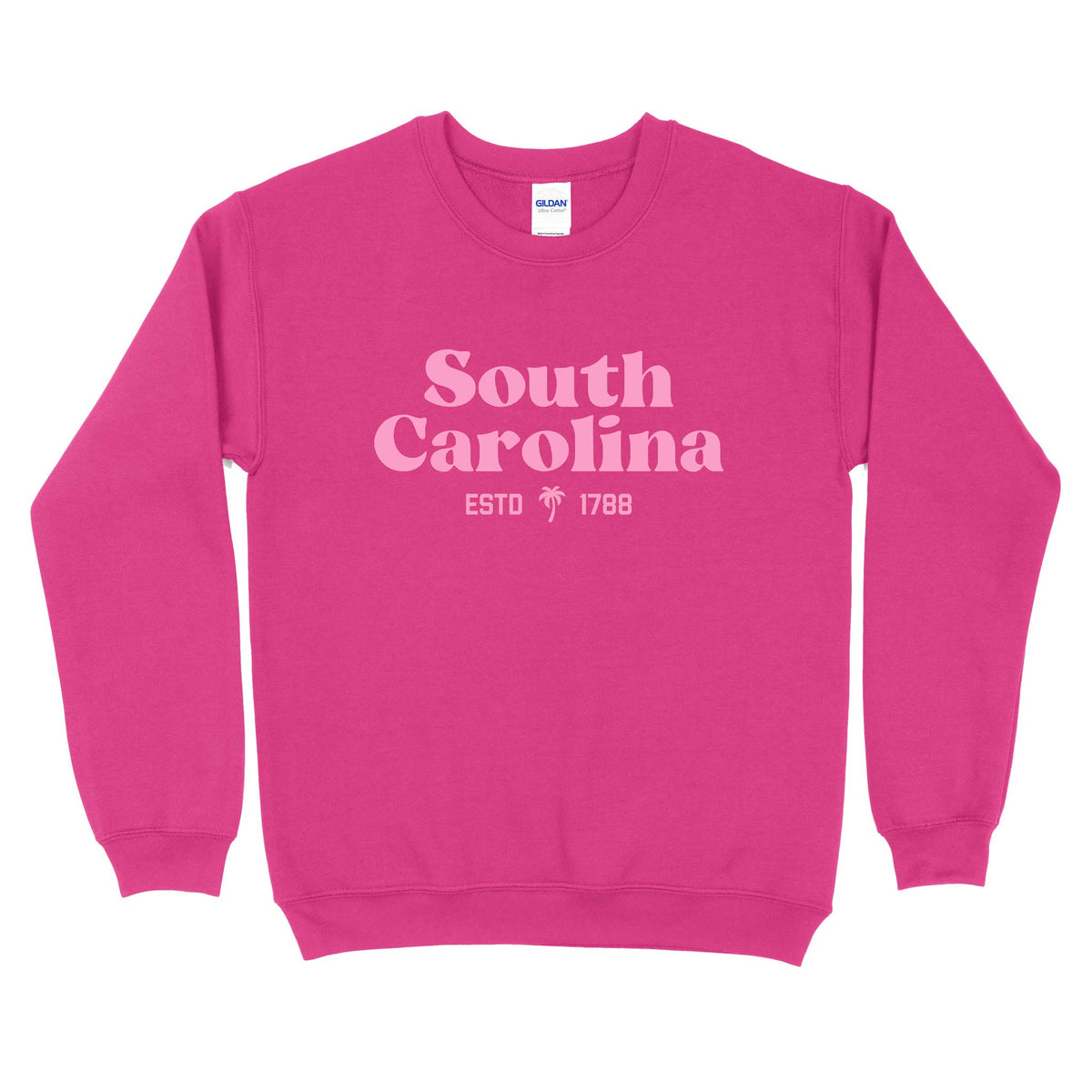 Hot pink crewneck sweatshirt featuring light pink “South Carolina ESTD 1788” text and a palm tree graphic printed on the front.