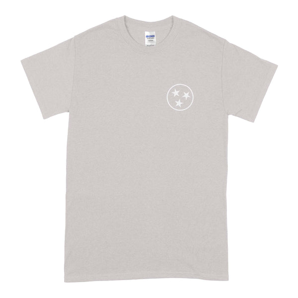  Front of light gray short sleeve t-shirt with small white three-star circle logo on the chest.