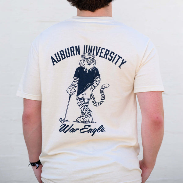 Ivory Auburn University t-shirt with large Aubie golf graphic and "War Eagle" text.