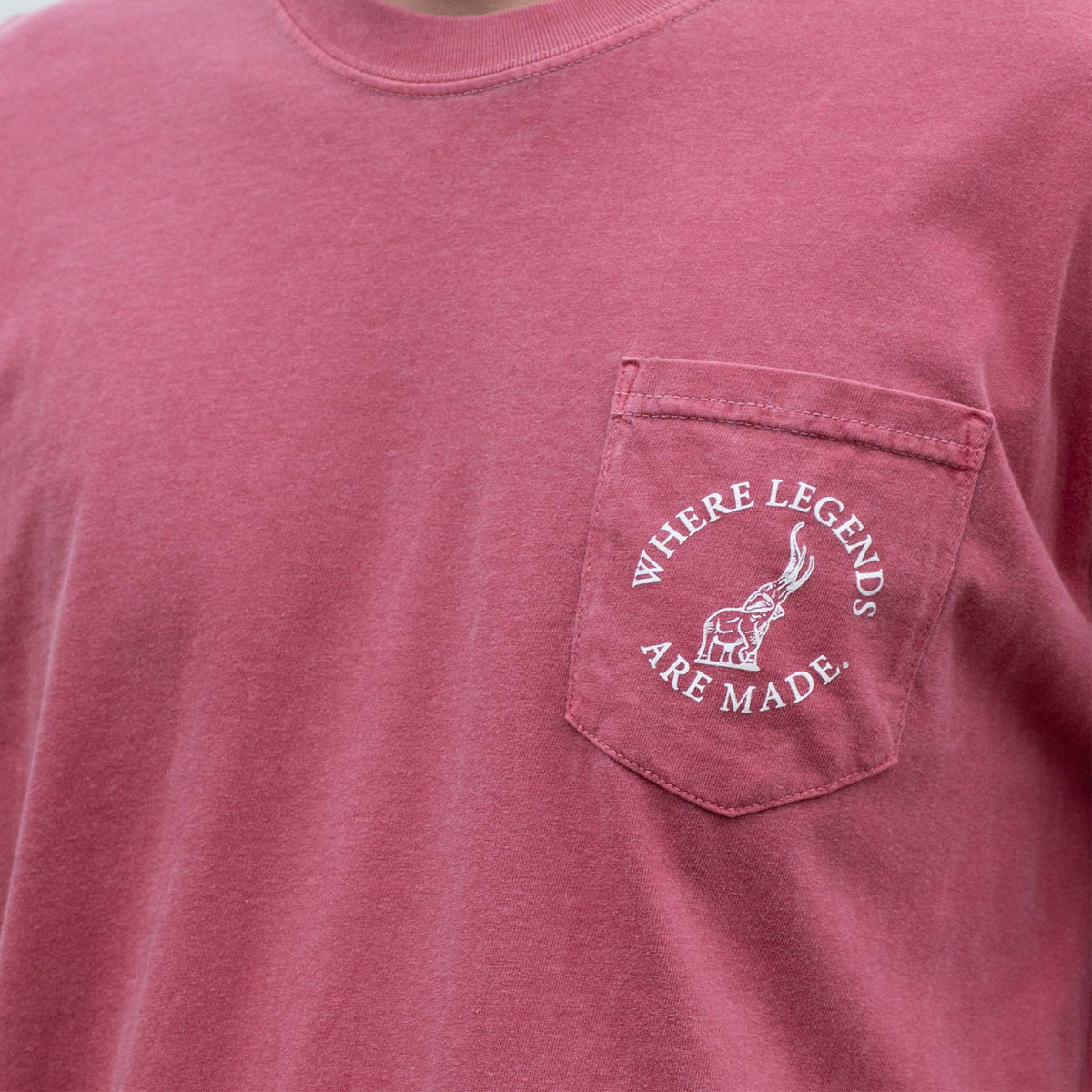 Front of crimson Alabama t-shirt with pocket featuring elephant graphic and “Where Legends Are Made” text.