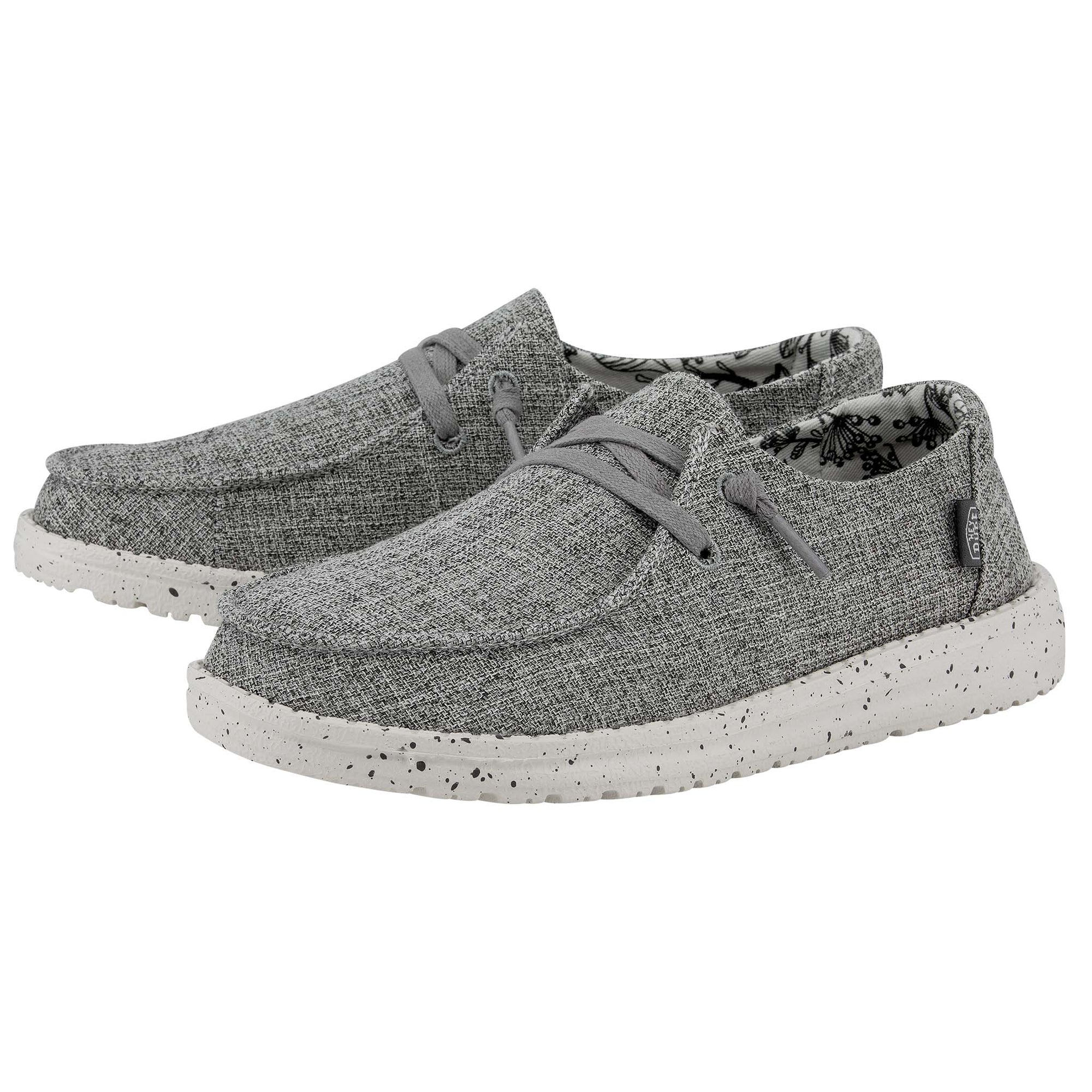 Pair of gray sneakers with speckled sole on a white background