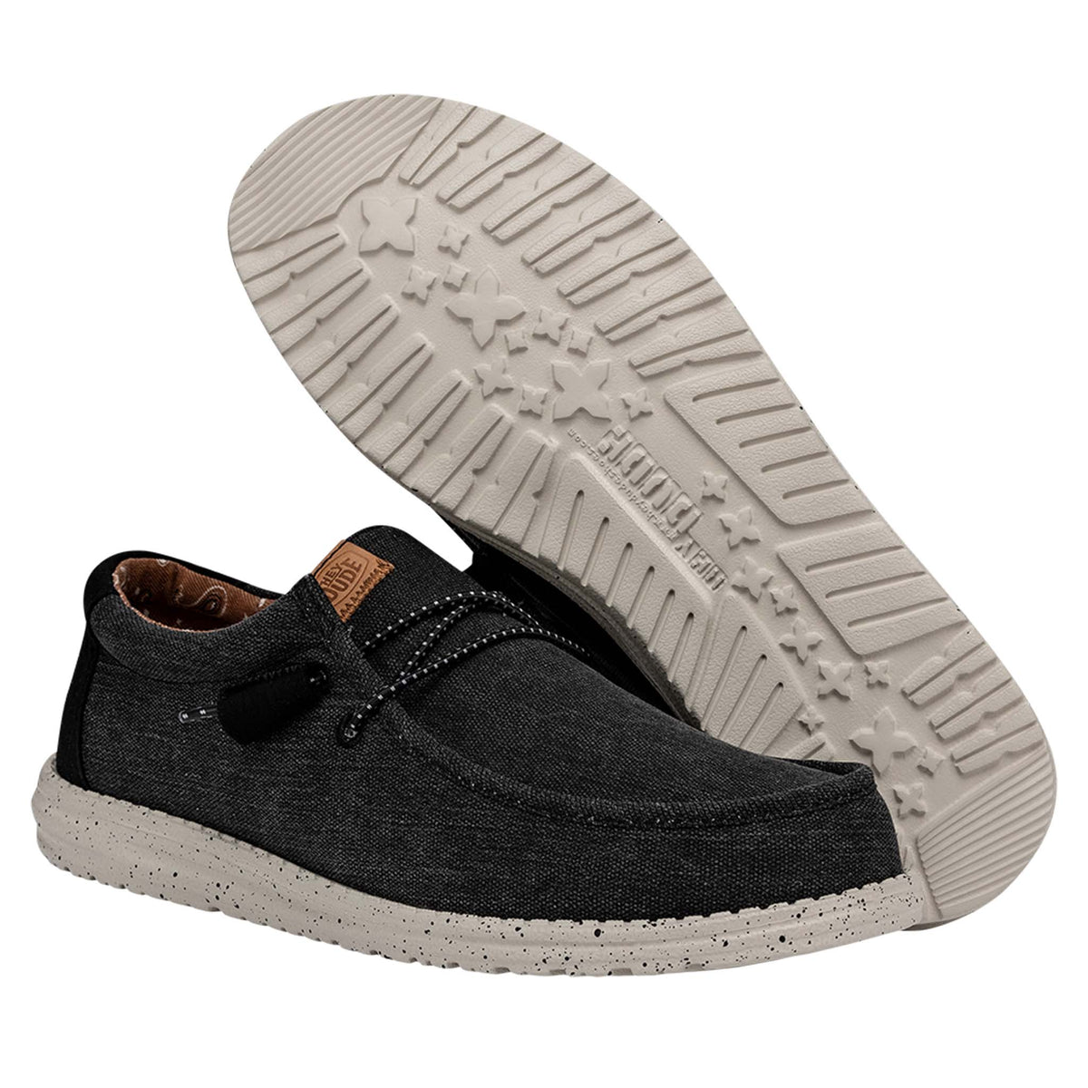 Black casual shoe with a white sole on a white background