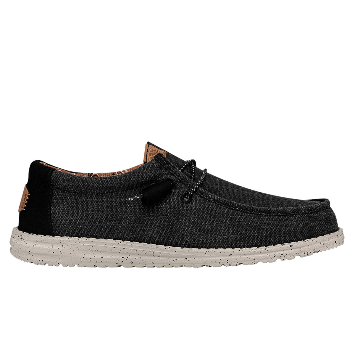 Black casual shoe with a white sole on a white background