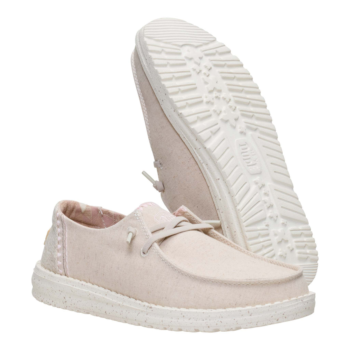 Pair of light pink sneakers with white soles on a white background