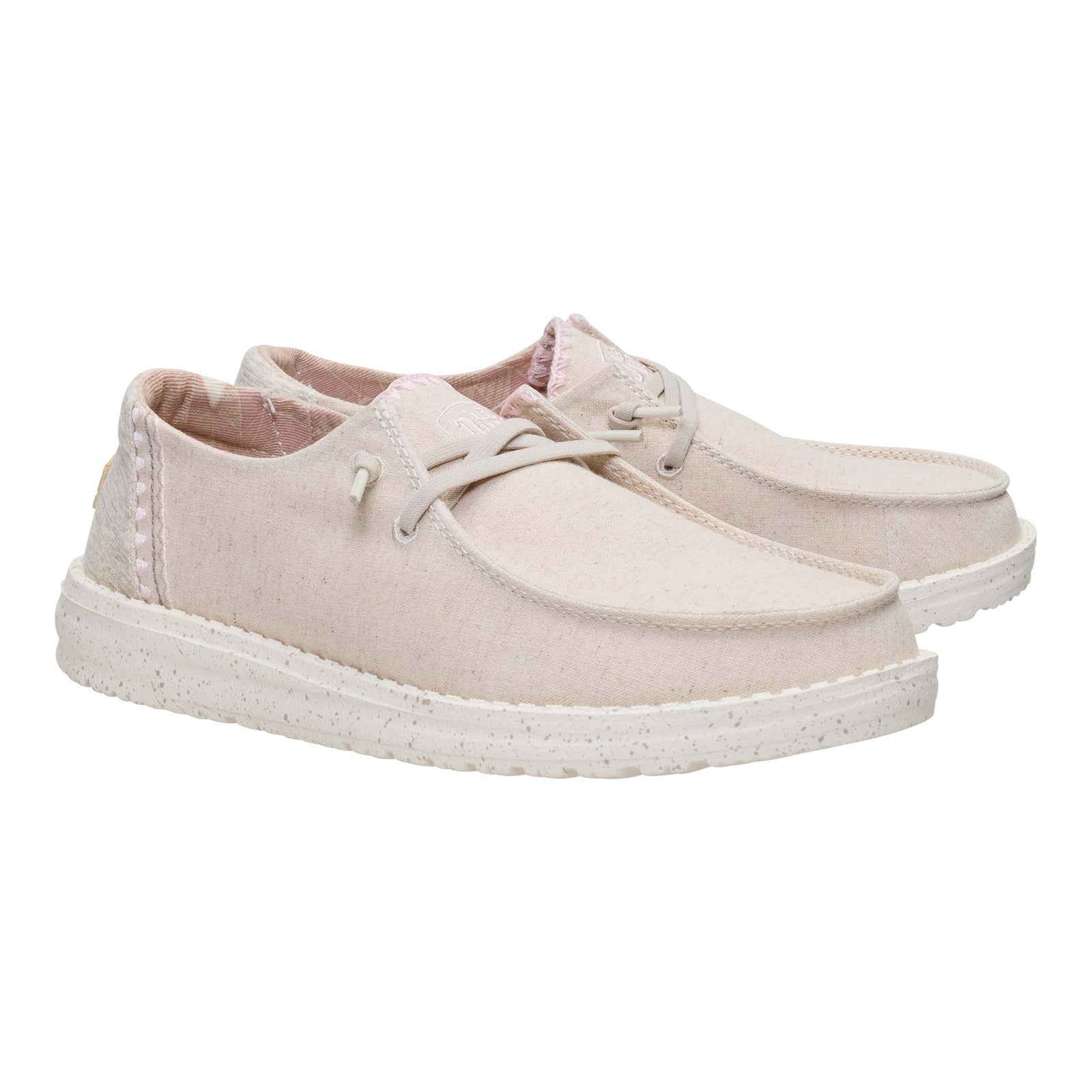 Pair of light pink sneakers on a white background