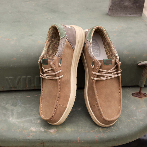 Pair of brown shoes on a green metal surface