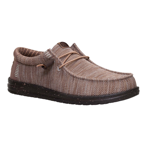 Brown shoe with black sole on a white background