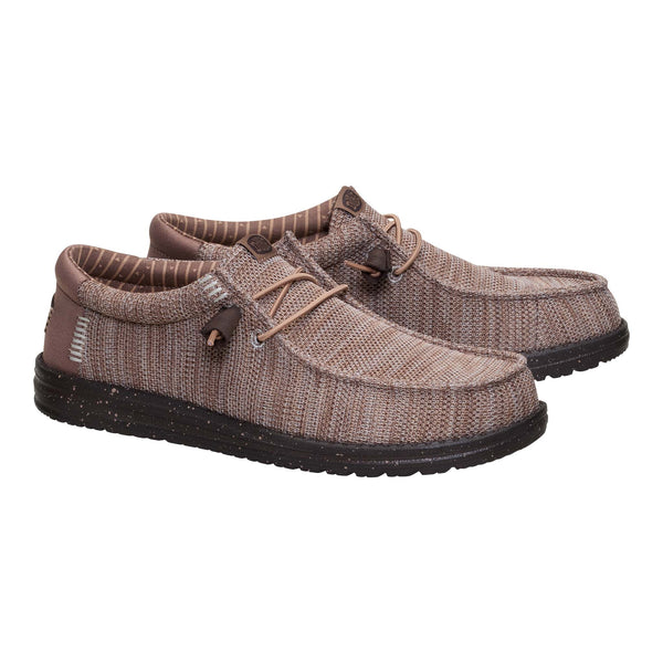 Pair of brown shoes with black soles on a white background