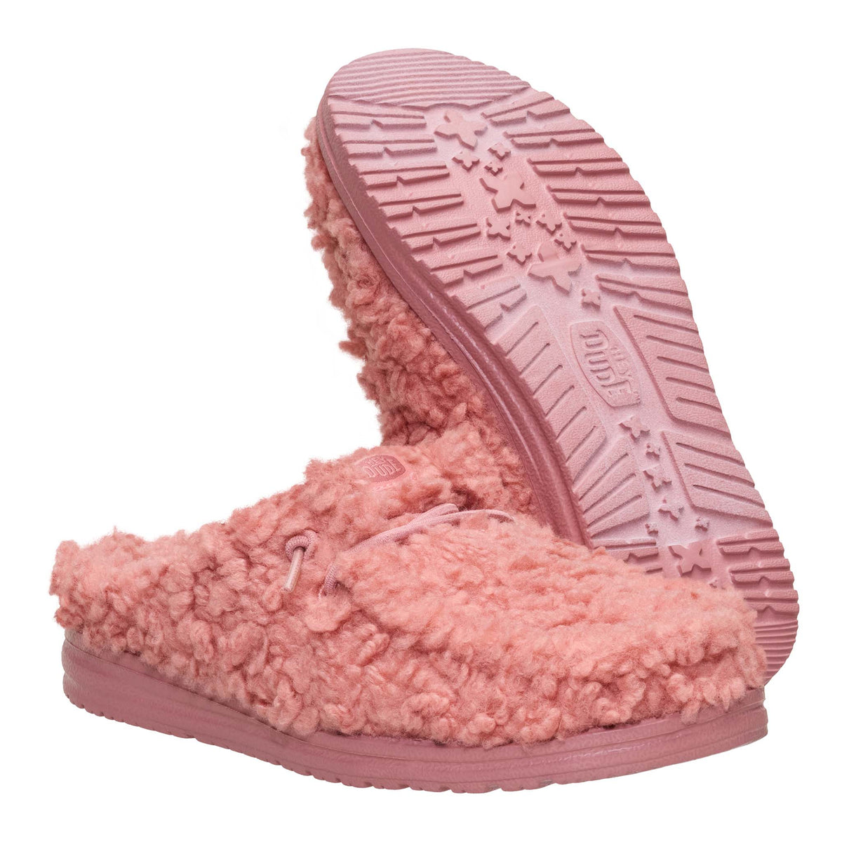 Pink fuzzy slippers with textured sole on a white background