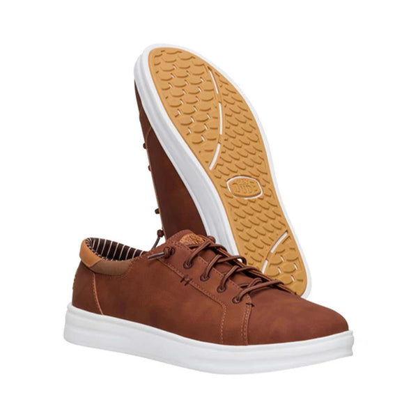 Pair of Hey Dude Paul Pro Classic Shoes in Cognac with one shoe showing the gum tread sole.
