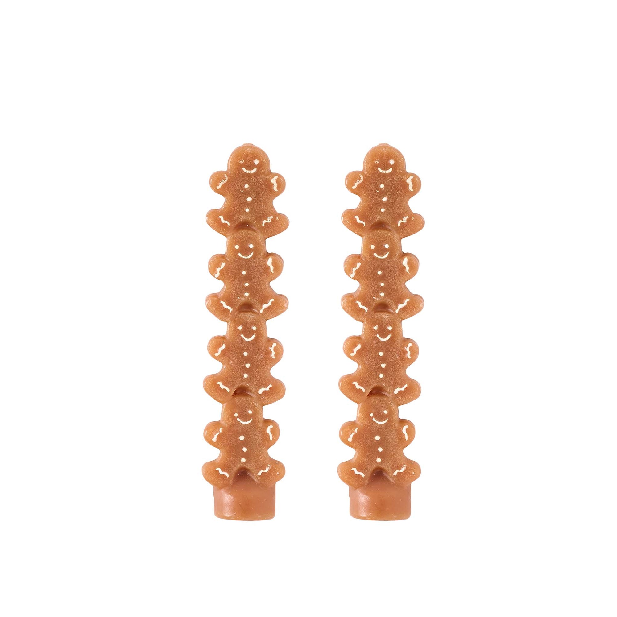 Two gingerbread man-shaped candles on a white background