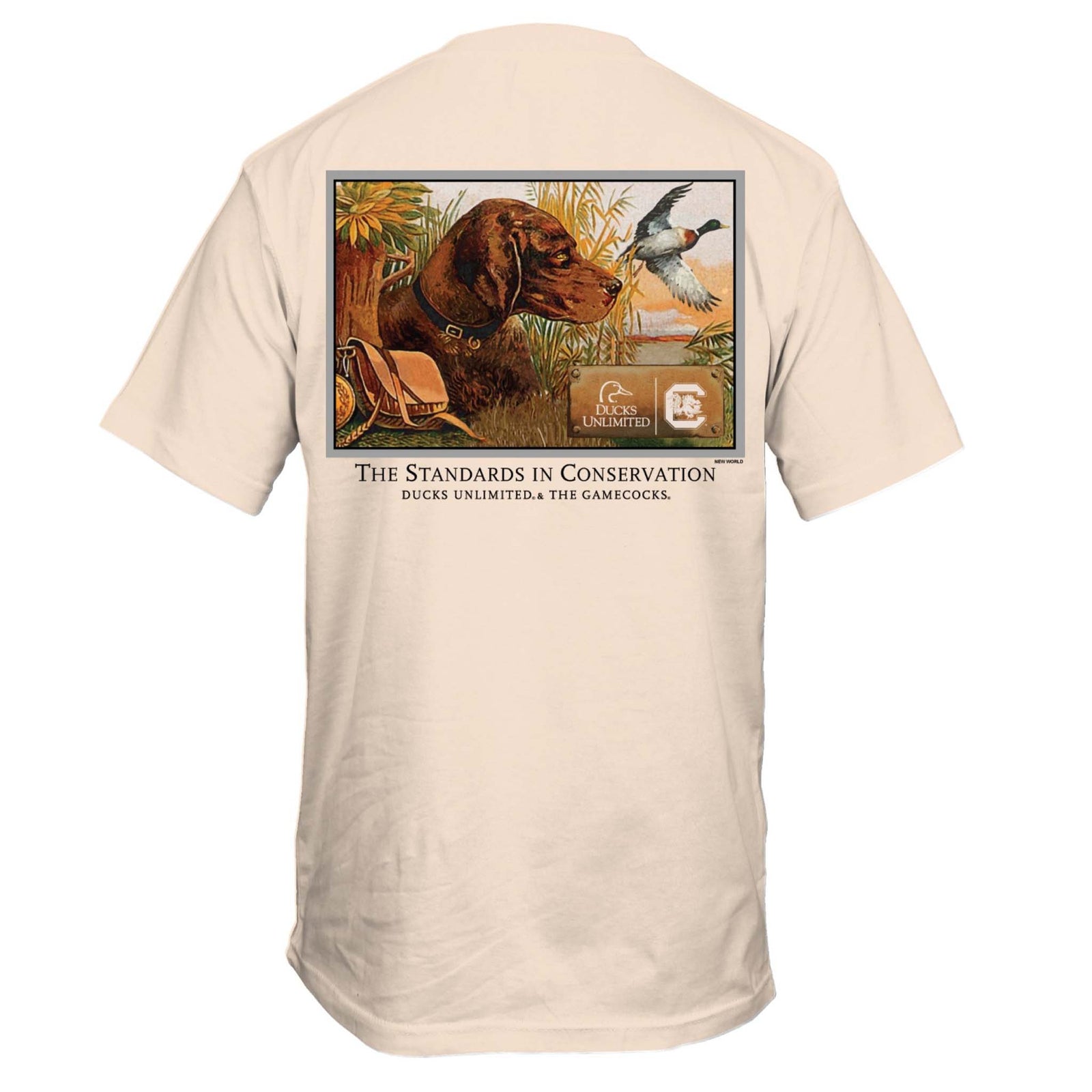 Ivory short sleeve t-shirt with large illustration of a hunting dog in grass, a flying duck, Ducks Unlimited and Gamecocks logos, and text reading “The Standards in Conservation.”
