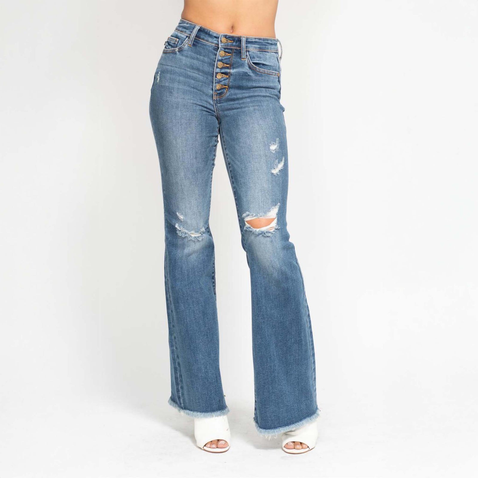 Front view of Judy Blue 5-button distressed flare jeans in medium wash, featuring a high-rise button fly, light distressing on the thighs, and a frayed hem at the bottom.