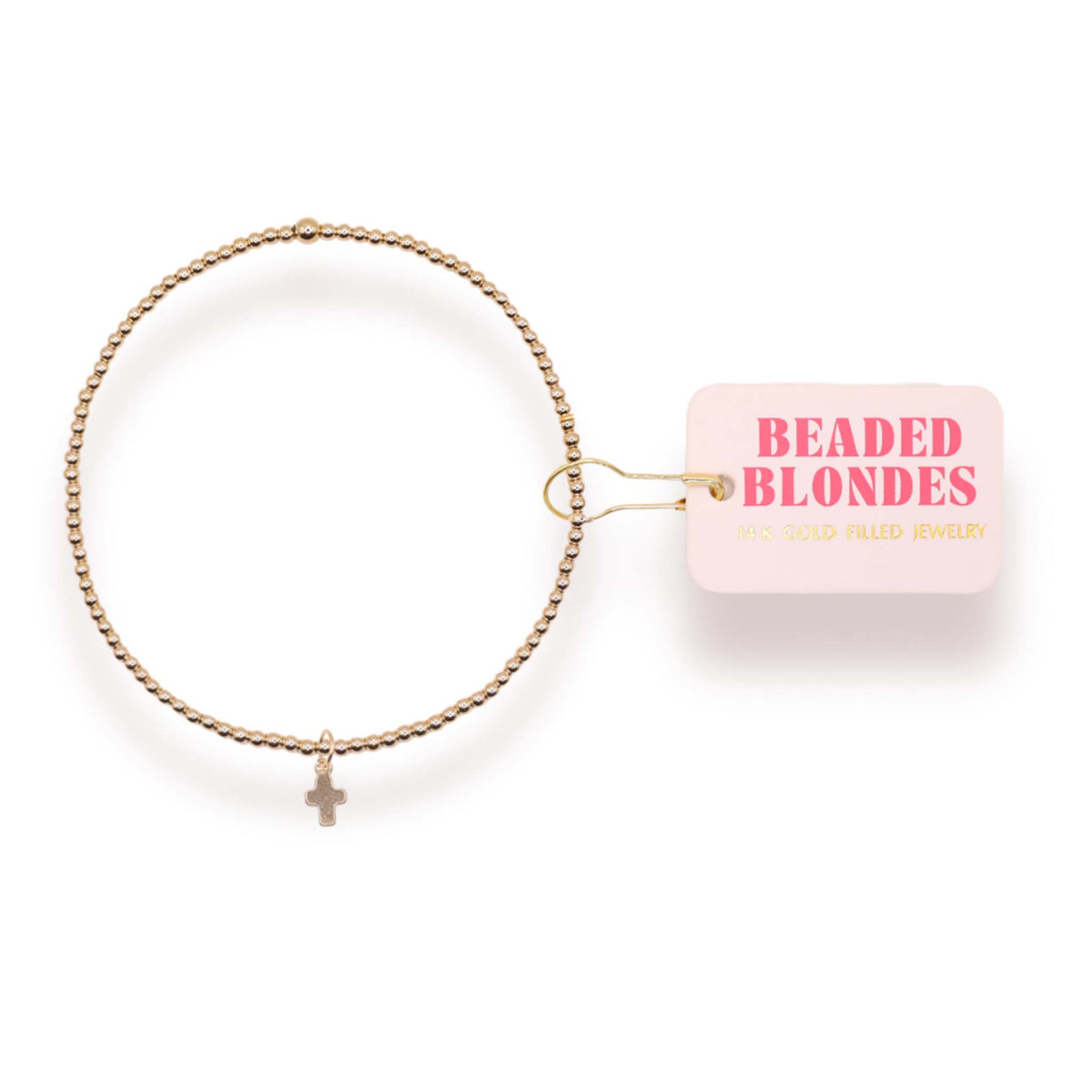 Gold bracelet with a small cross charm on a white background, featuring 'Beaded Blondes' packaging.