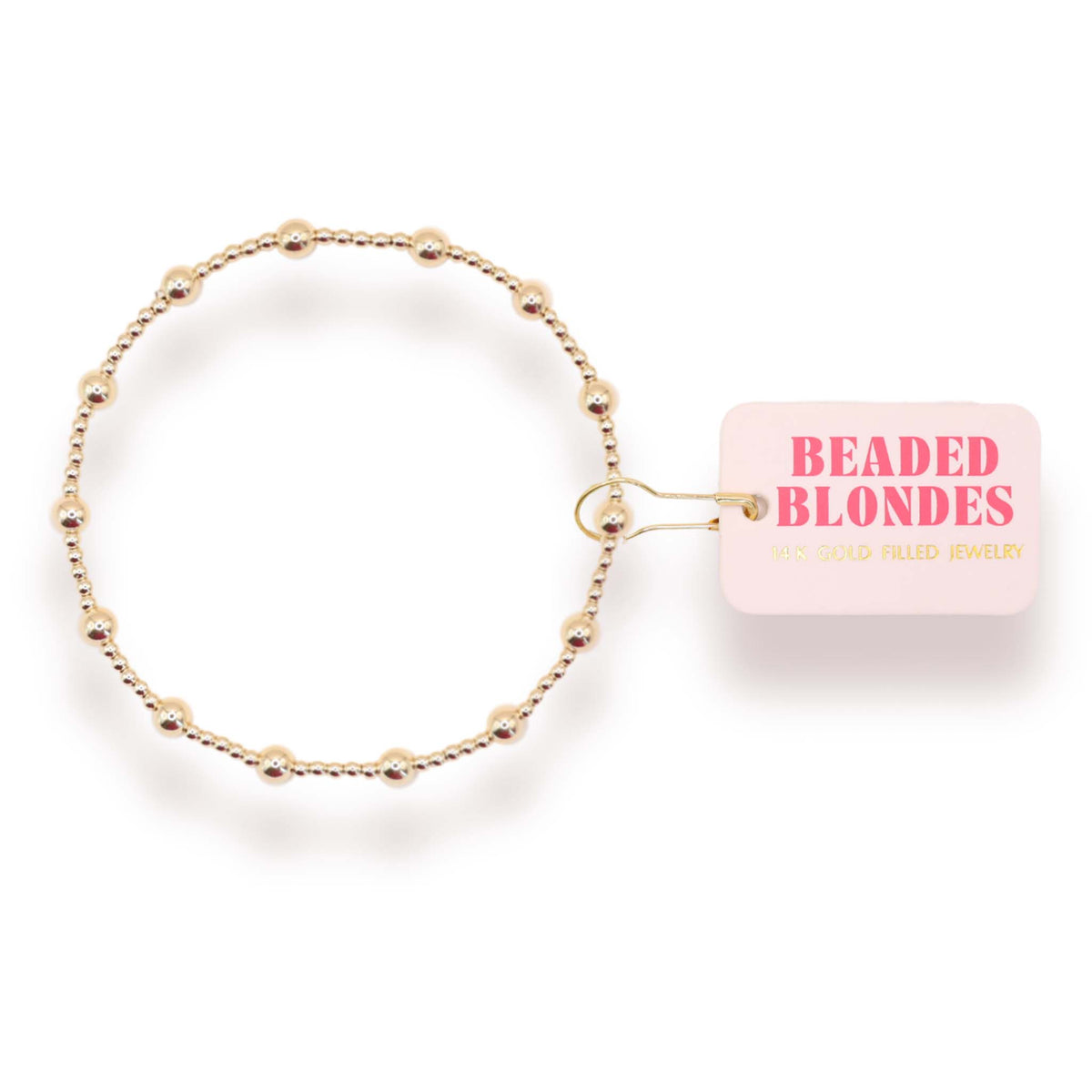 Gold beaded bracelet with a pink packaging box labeled 'Beaded Blondes' on a white background