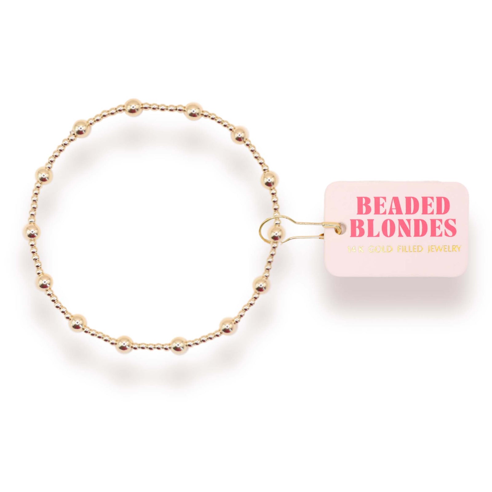 Gold beaded bracelet with a pink packaging box labeled 'Beaded Blondes' on a white background