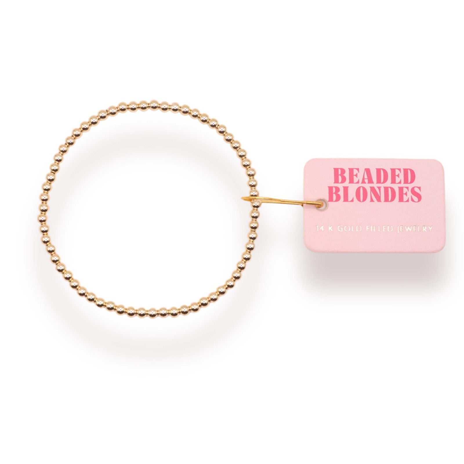 Gold beaded hair tie with a pink tag labeled 'Beaded Blondes' on a white background