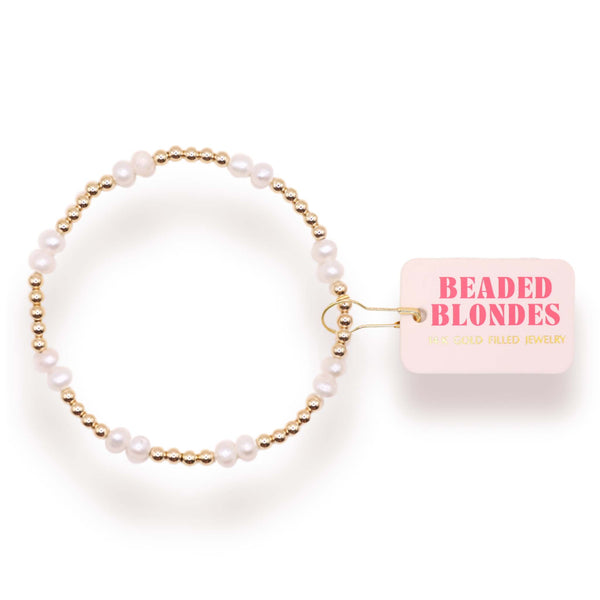 Pearl hair tie with gold accents on a white background, featuring 'Beaded Blondes' packaging.