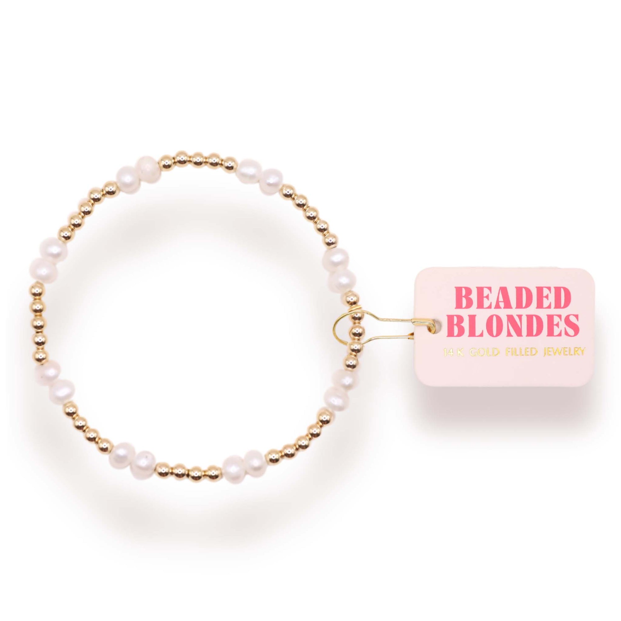 Pearl hair tie with gold accents on a white background, featuring 'Beaded Blondes' packaging.