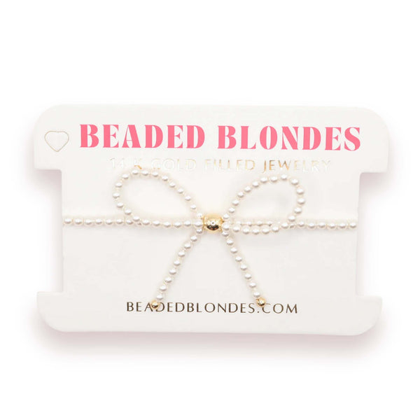 Beaded blondes jewelry set on a branded card with website information.