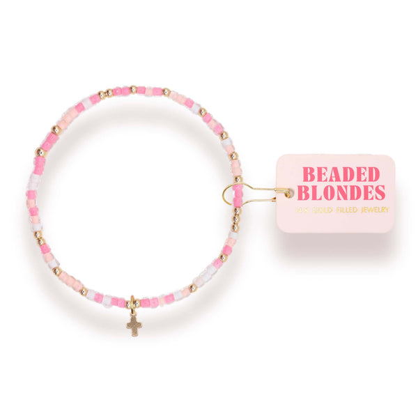 Pink beaded bracelet with gold accents and a small pink box labeled 'Beaded Blondes' on a white background.
