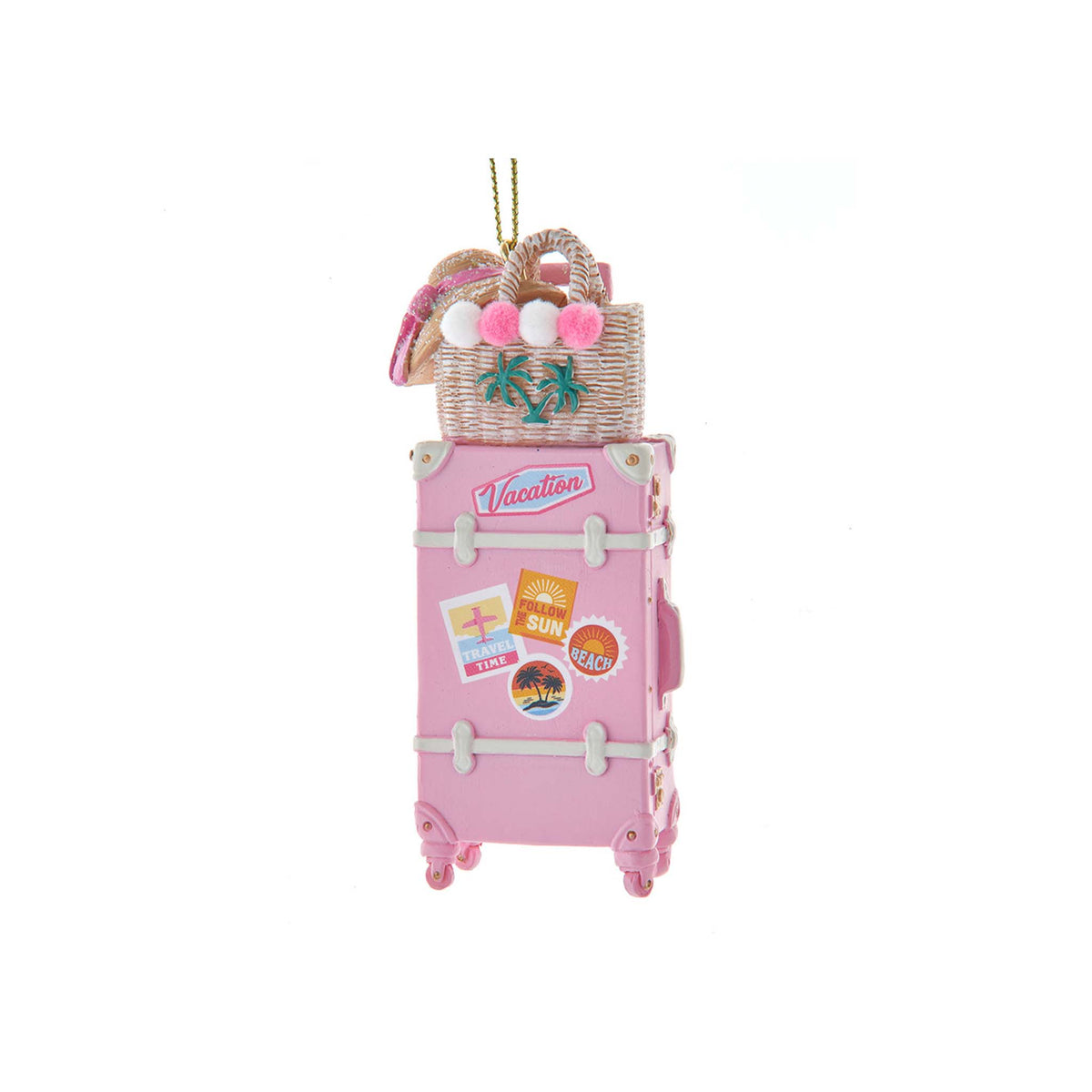 Pink suitcase ornament with travel stickers, topped with a beach bag, flip flops, and pom-pom accents