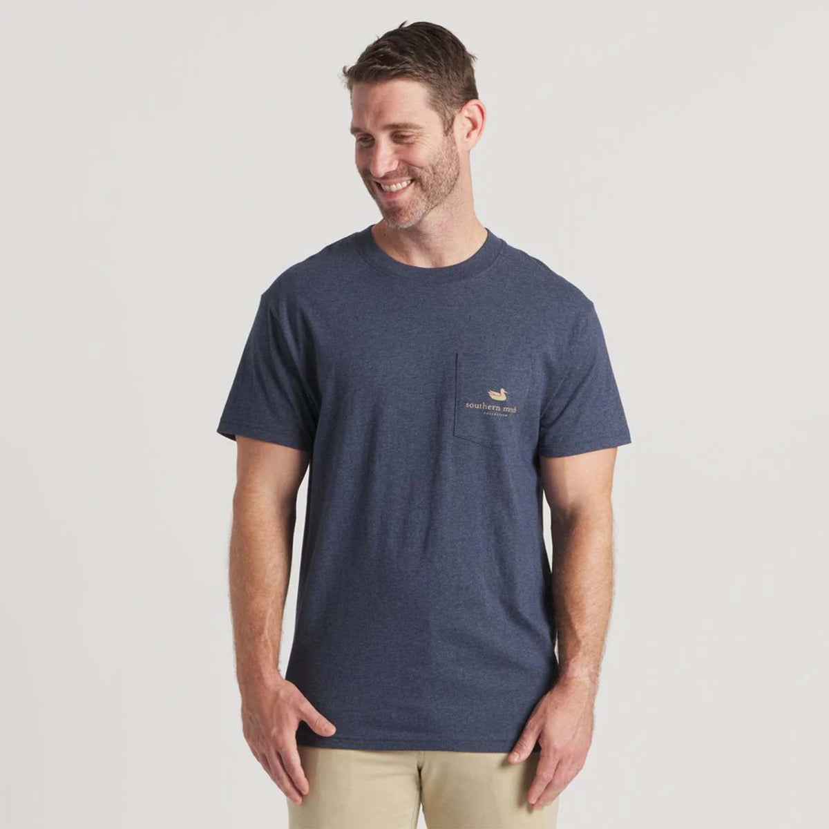 Man wearing navy Southern Marsh short sleeve tee with front chest pocket featuring small duck logo and Southern Marsh text.