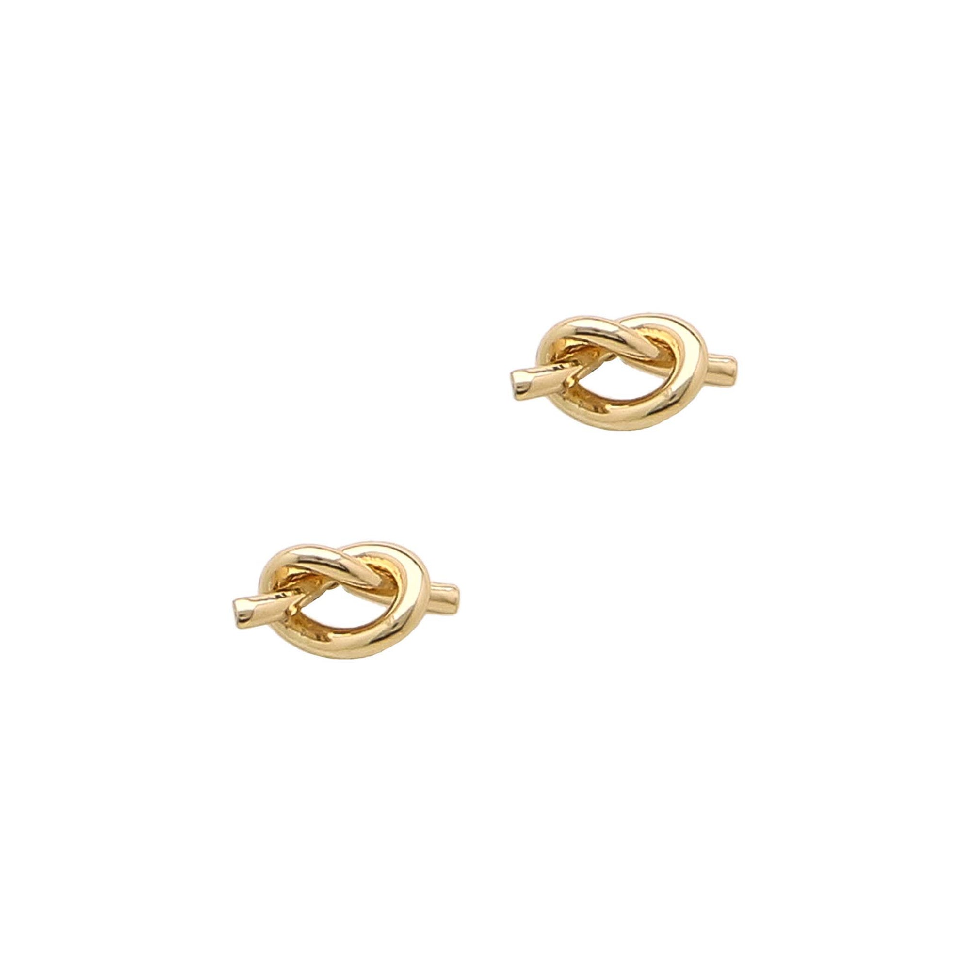 Two gold knot-shaped earrings on a white background