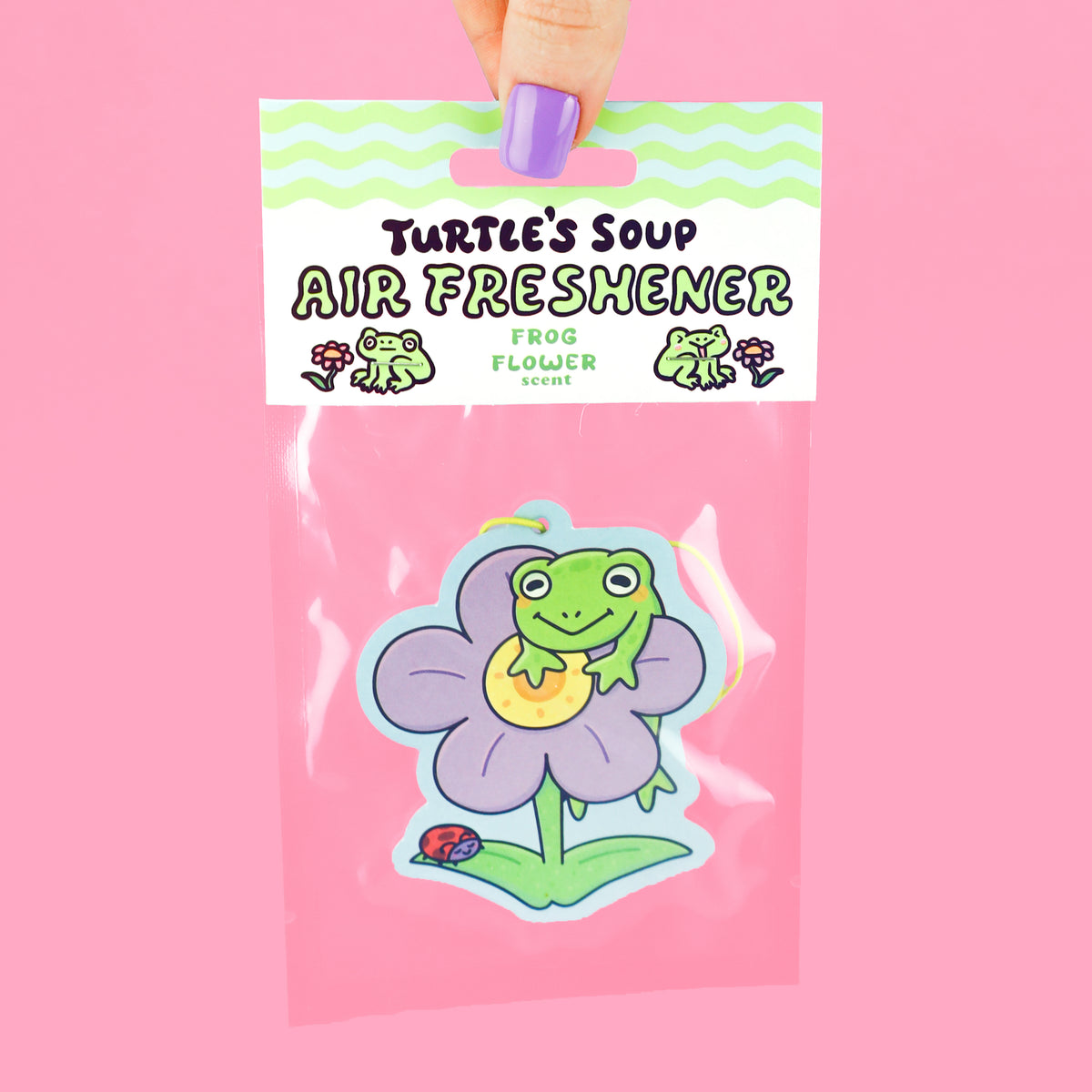 Frog hanging on a flower air freshener
