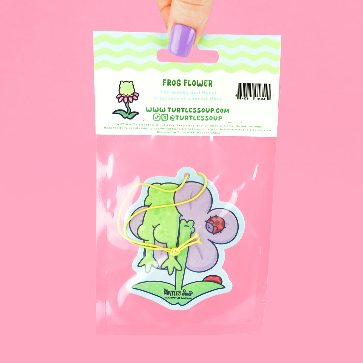 Frog hanging on a flower air freshener