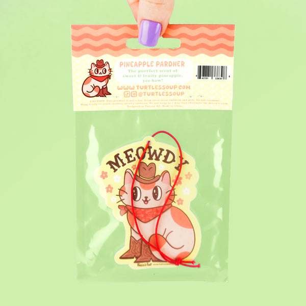 Packaged product with a cat-themed air freshener labeled 'MEOWDY' on a green background