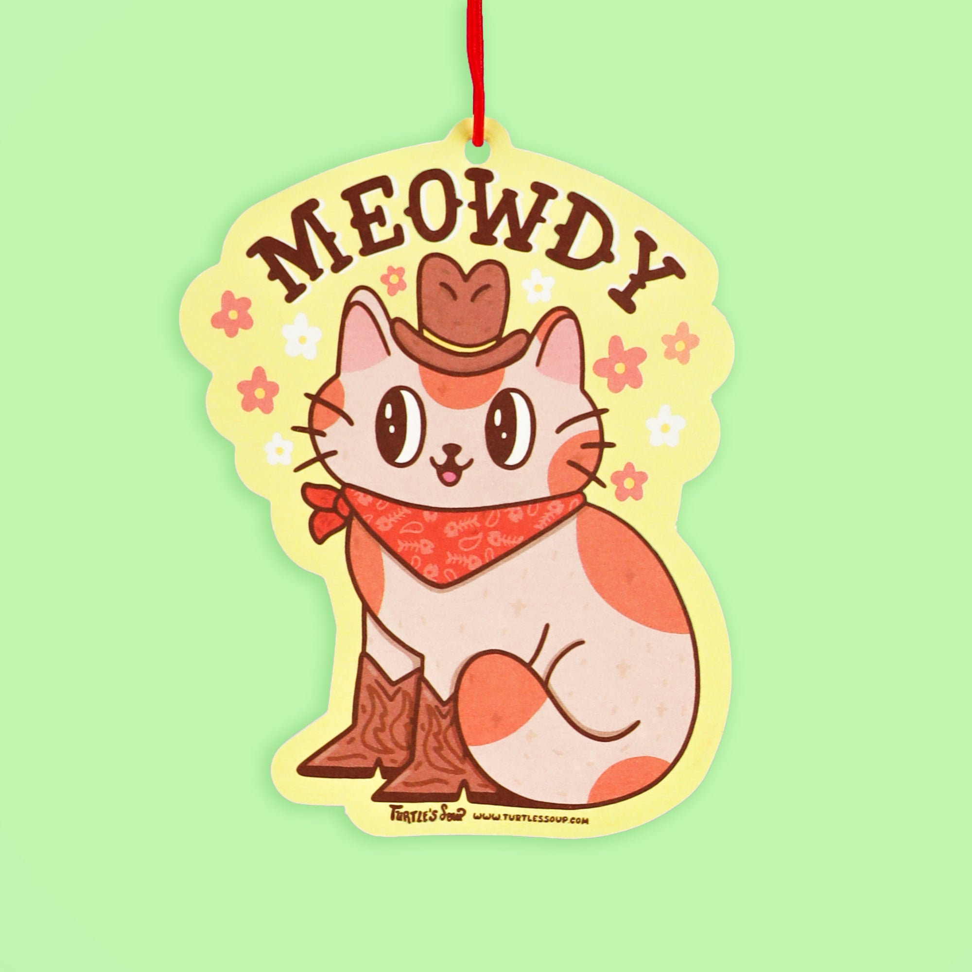 air freshener of a cat in cowboy attire with 'MEOWDY' text on a light green background