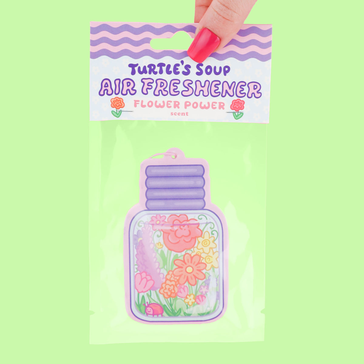 Turtle's Soup Air Freshener with floral design on a green background