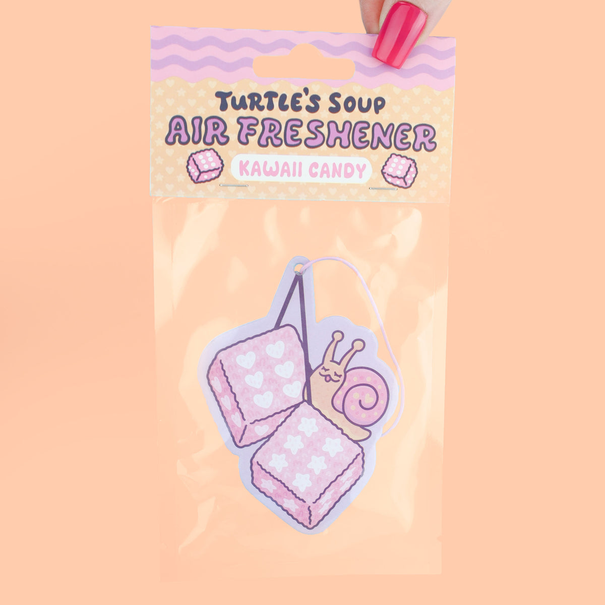 Air freshener packaging with a snail design on a peach background