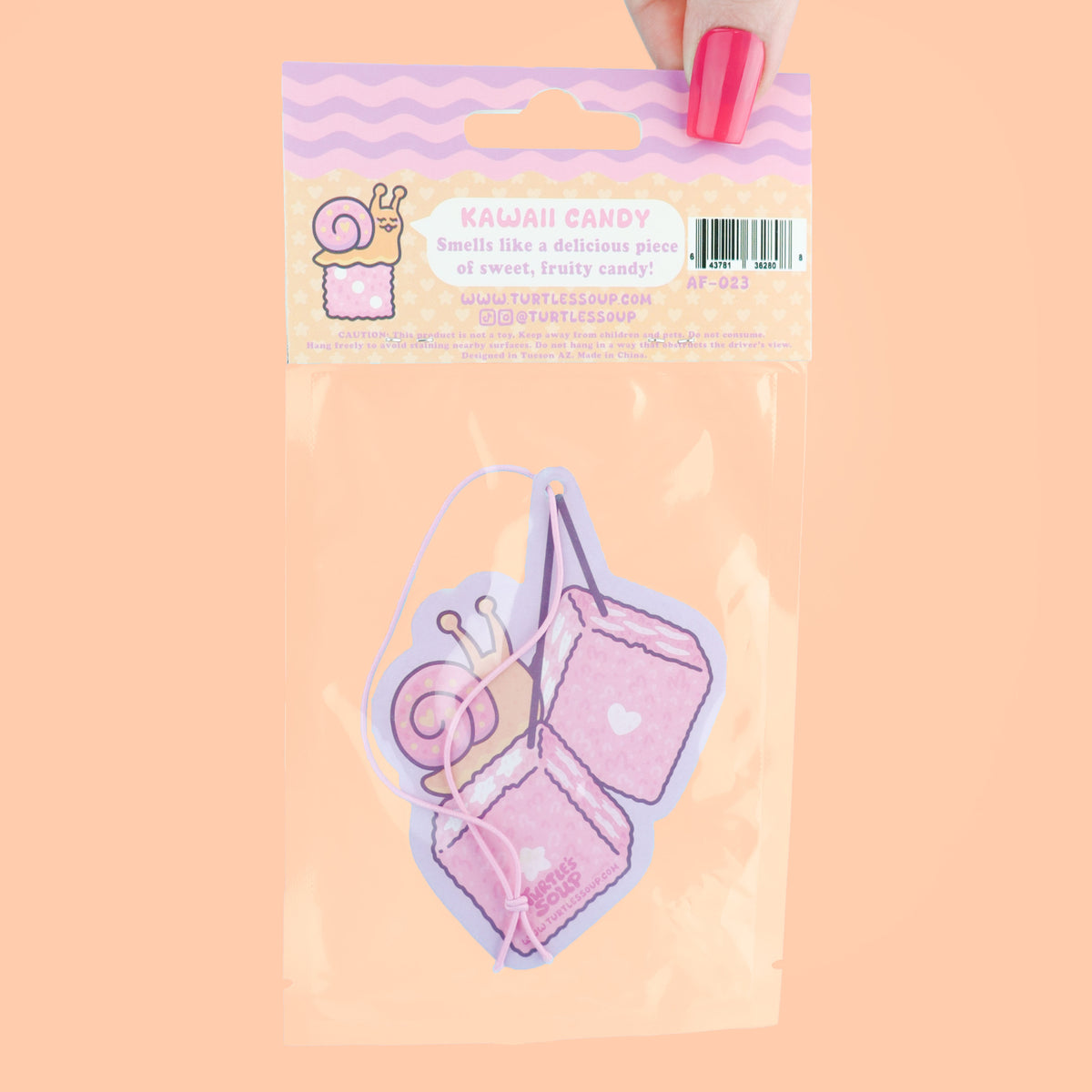 Air freshener packaging with a snail design on a peach background
