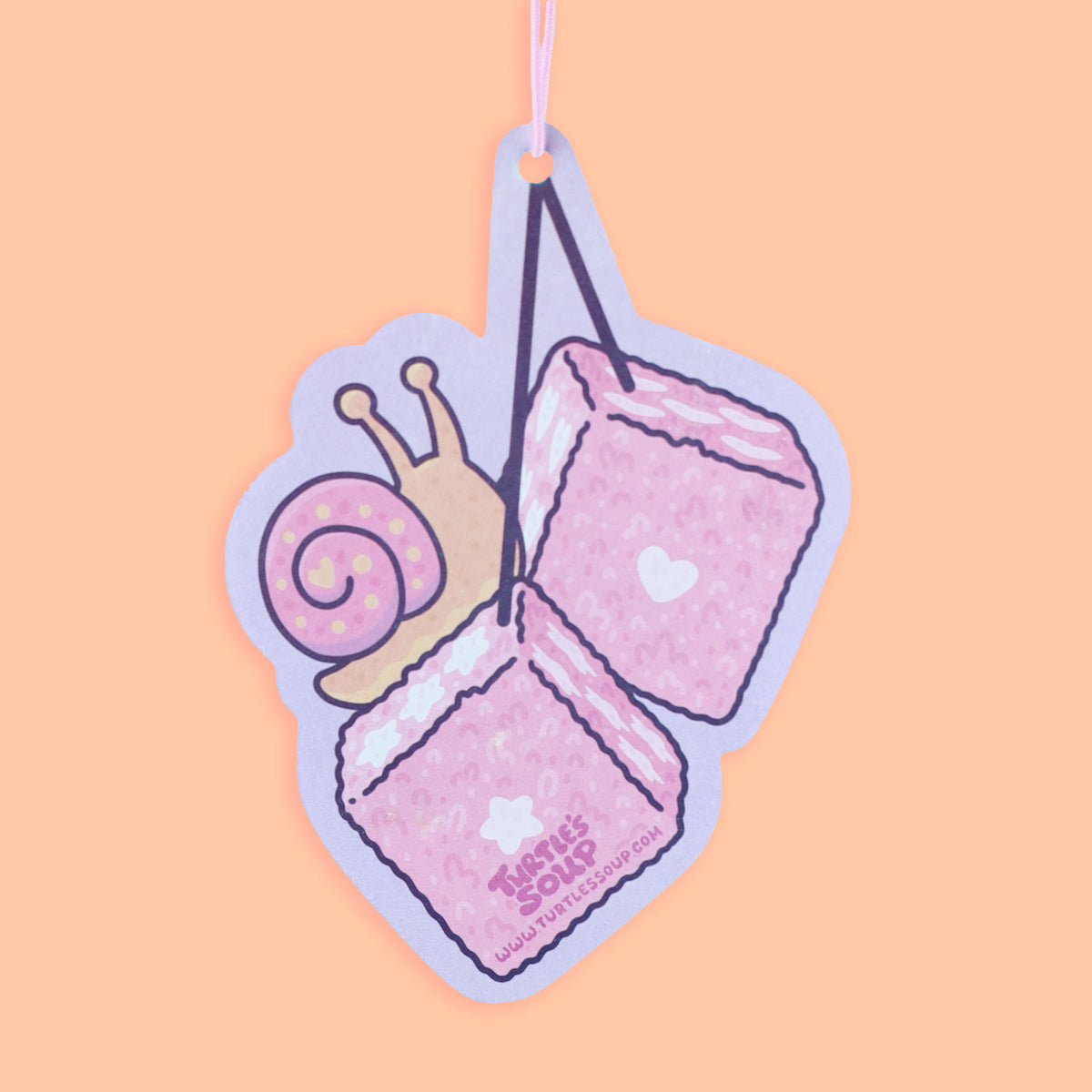 Pink dice with a snail design on a pastel pink background