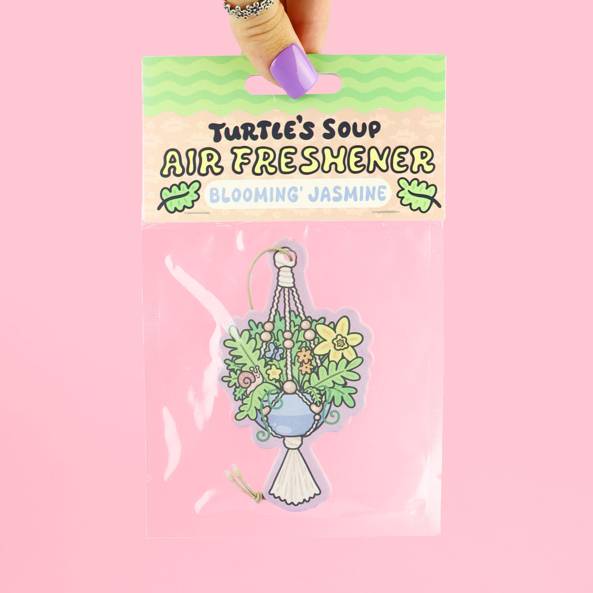 Air freshener packaging with 'Turtle's Soup' branding on a pink background