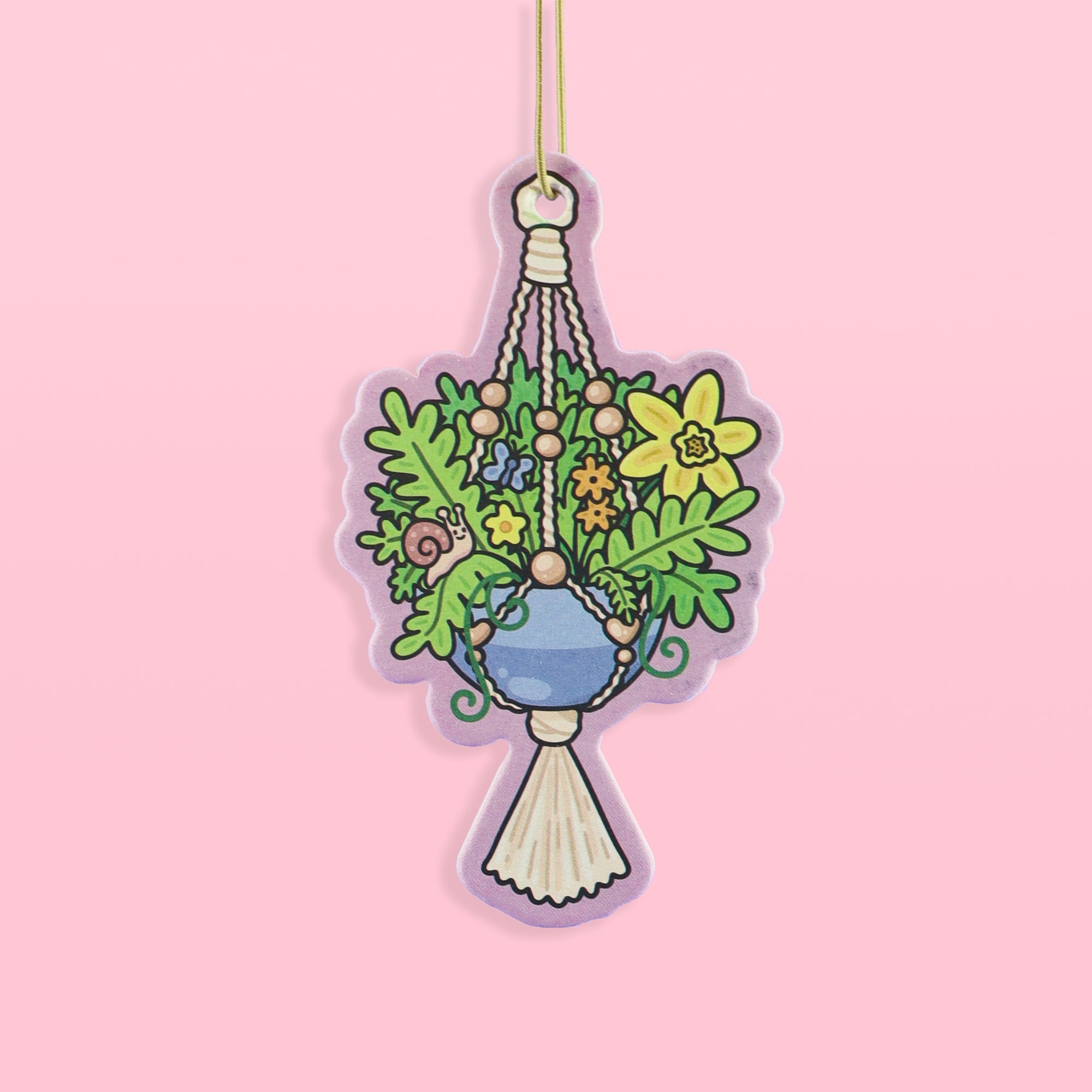 Decorative hanging plant air freshener on a pink background