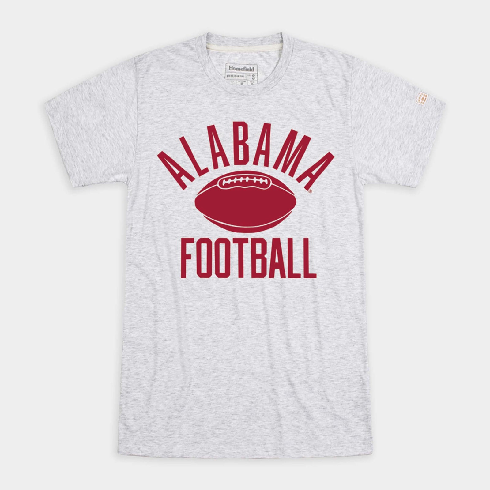Front view of light ash grey short sleeve t-shirt with crimson text reading “Alabama Football” and a football graphic in the center.