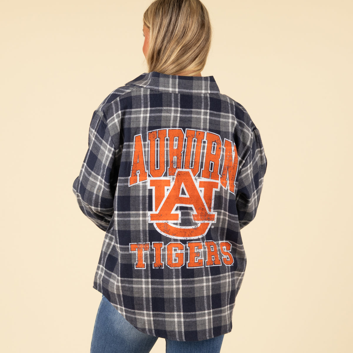 Person wearing a plaid flannel shirt with 'Auburn Tigers' text on the back